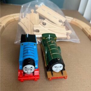 Thomas the Tank Engine and Emily engines on compatible wooden tracks.